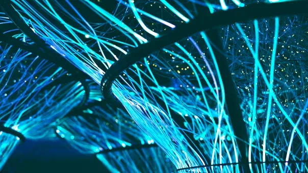 Close-up of glowing blue fibre-optic strands carrying data