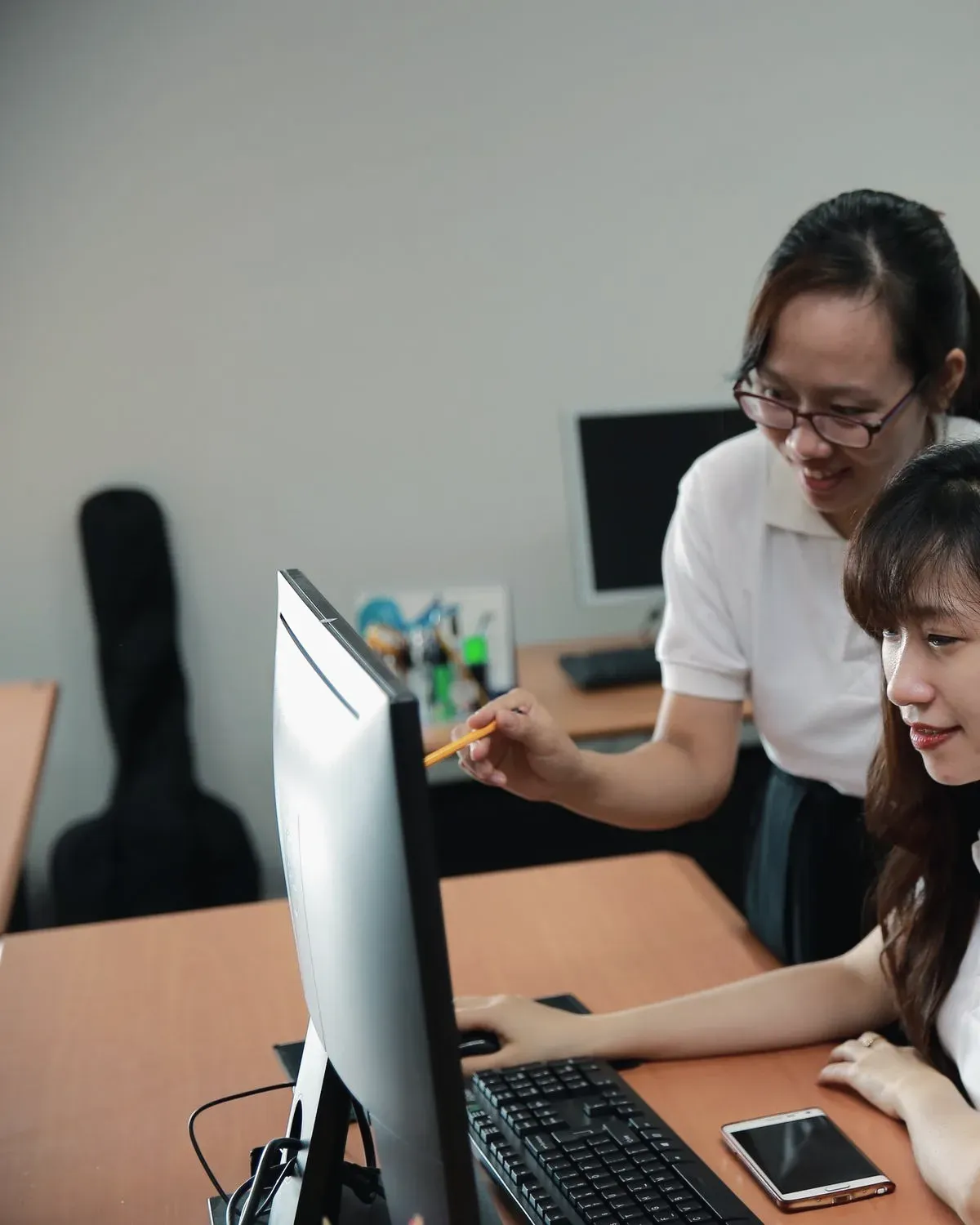 Two engineers reviewing a screen together before signing off