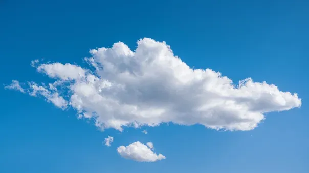 A single white cloud in a clear blue sky