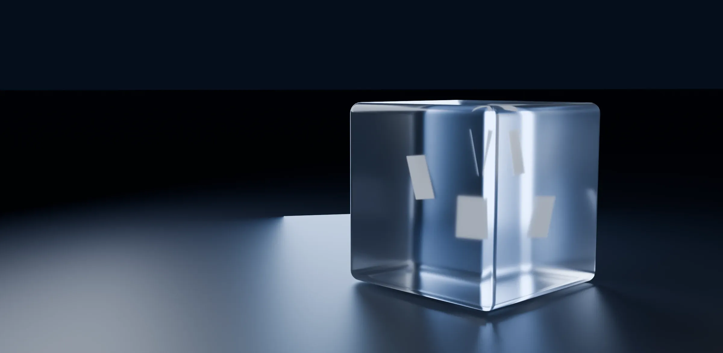 A frosted glass cube lit from inside, standing alone on a dark floor