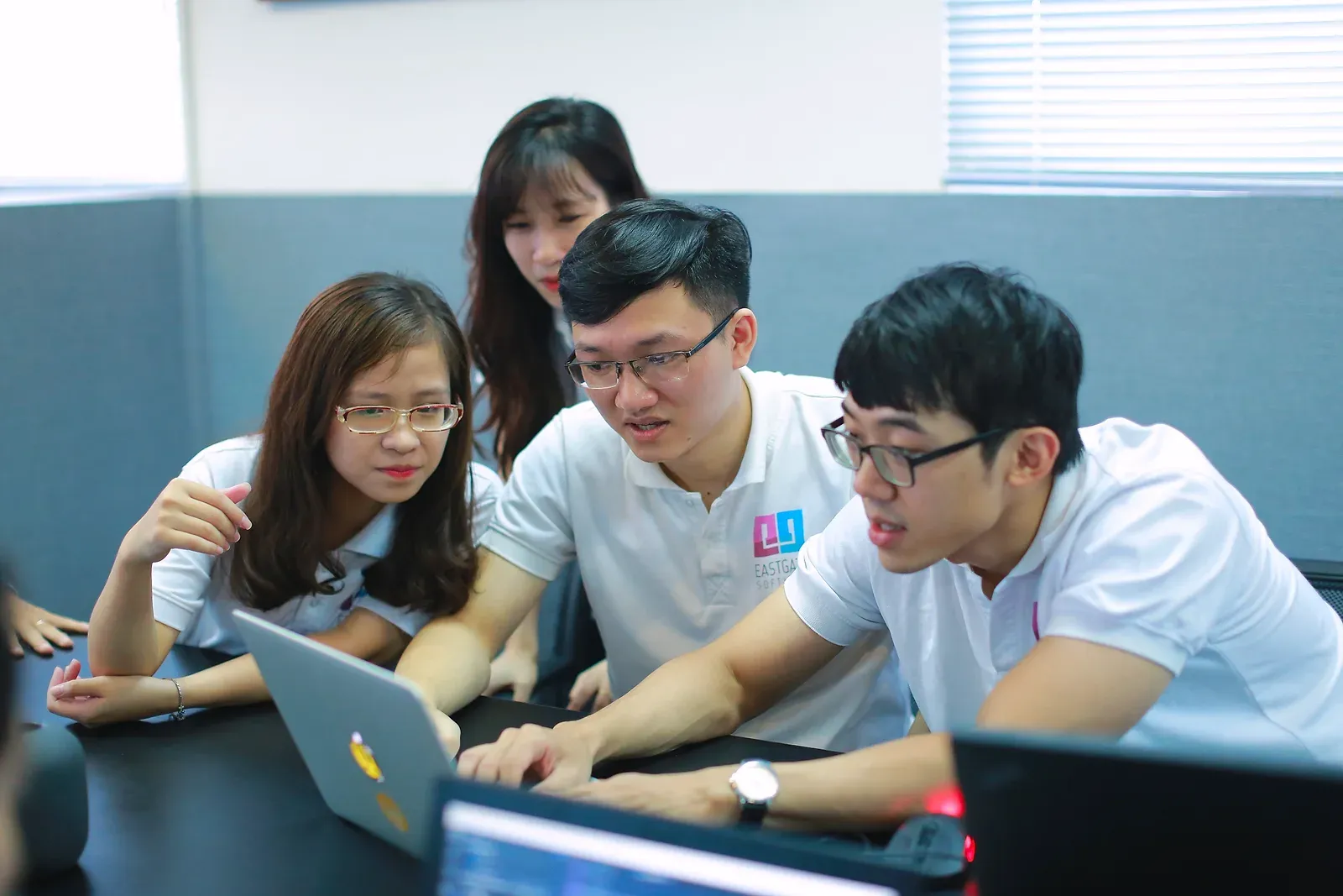 Eastgate engineers working through code together at a laptop