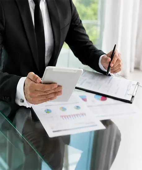 Engineer reviewing printed performance charts alongside a tablet