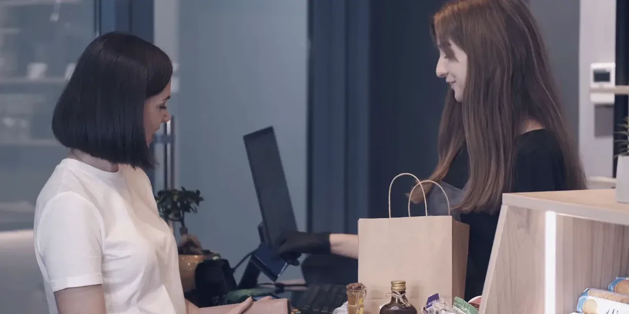Customer paying by card at a store checkout counter