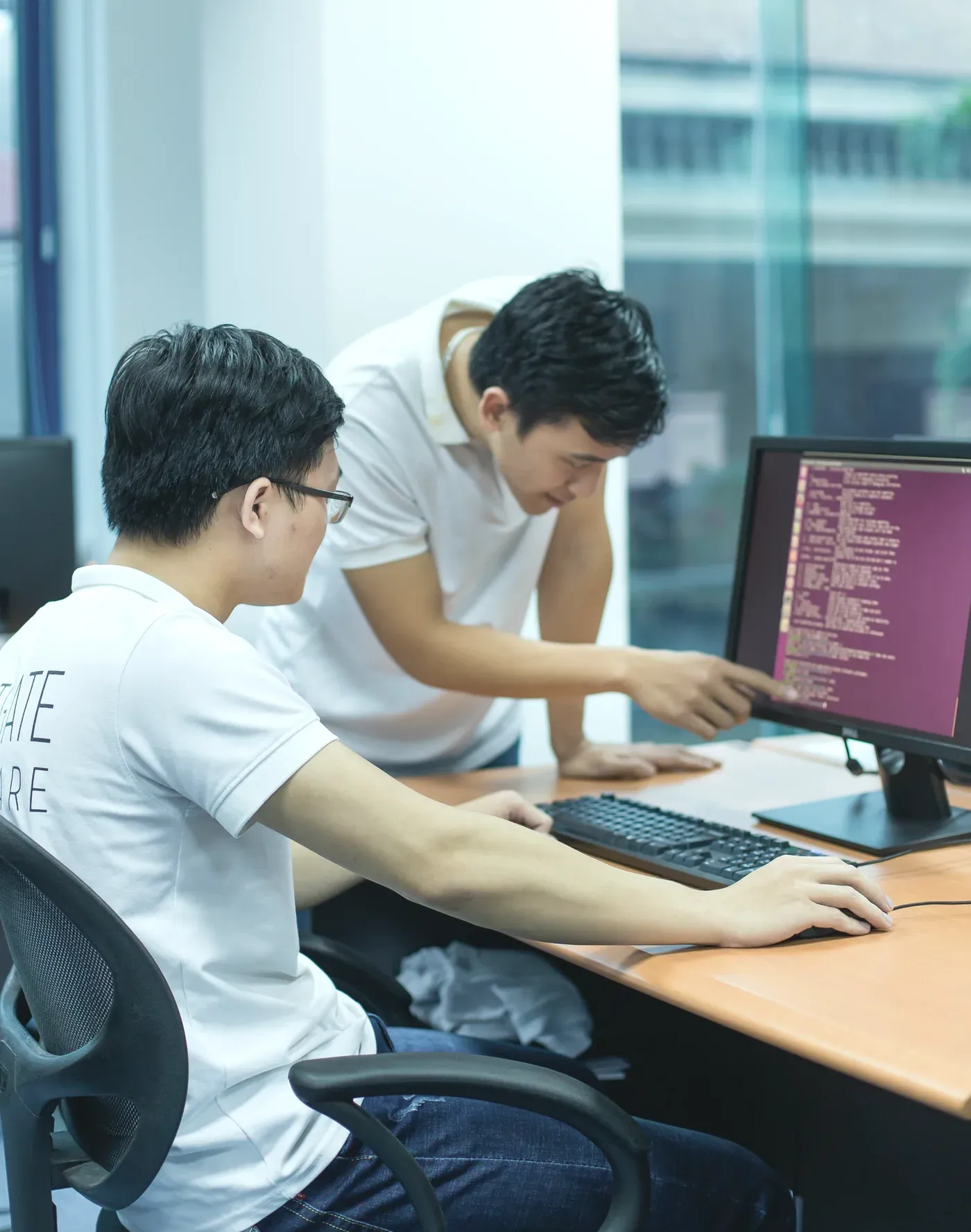Two Eastgate engineers reviewing code together at a workstation